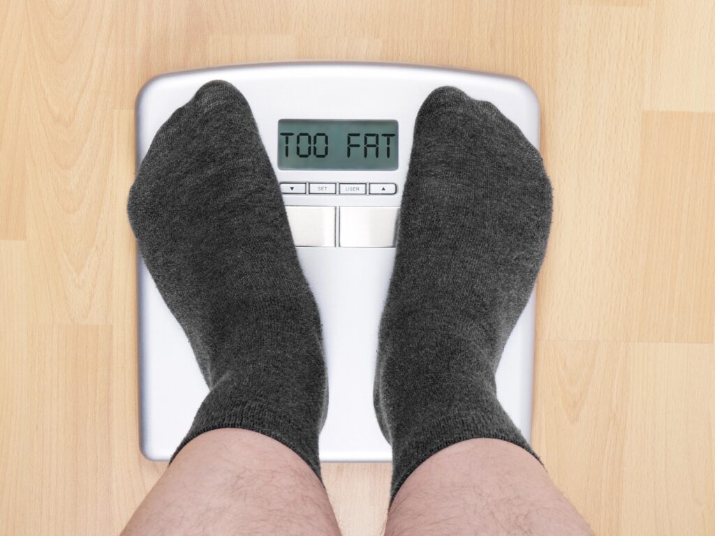 fat man on scales Weight Loss for Over 50s