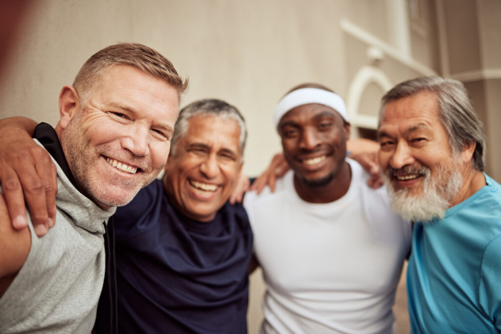 group of men arms on shoulders smiling