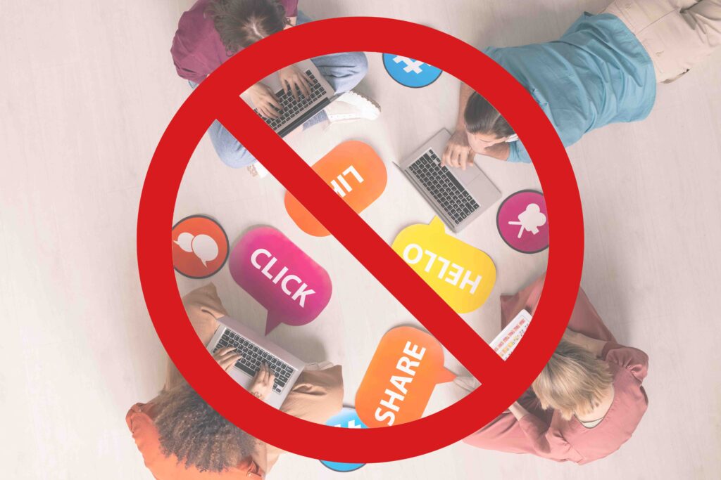 social media restrictions banned with people working on laptops