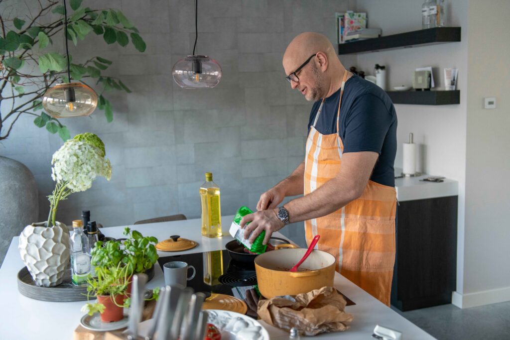 middle aged man cooking for his wife