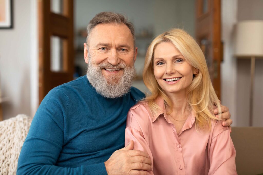 mature husband and wife on sofa hugging