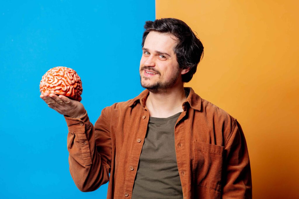 man holding a brain - looks happy