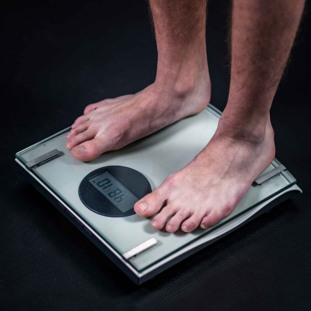 mans feet on weighing scales