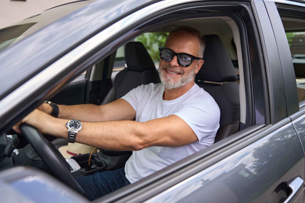 mature man using his own car for delivering food as his side hustle